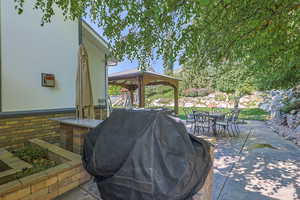 View of patio / terrace with area for grilling and a gazebo