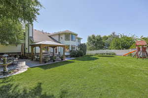 View of yard featuring a playground, a gazebo, and a patio