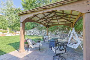 View of patio / terrace with an outdoor fire pit and a gazebo