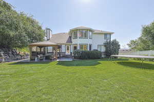 Back of property with a yard and a patio area