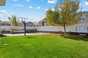 View of yard with a patio and a trampoline