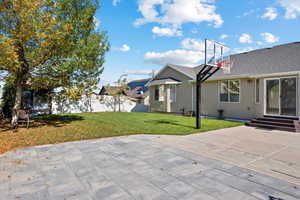 View of basketball court with a lawn