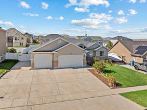 View of front of property with a front lawn and a garage