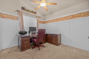 Office area with lofted ceiling, light colored carpet, and ceiling fan