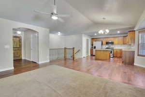 Kitchen featuring appliances with stainless steel finishes, lofted ceiling, and dark hardwood / wood-style floors