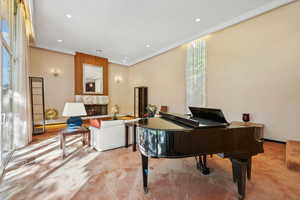 Misc room featuring a high end fireplace and light colored carpet