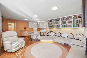 Living room featuring light hardwood / wood-style flooring and a notable chandelier