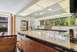 Kitchen featuring white cabinetry, stainless steel appliances, and plenty of natural light