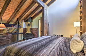 Bedroom featuring vaulted ceiling with beams and wooden ceiling