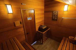 View of sauna with wood-type flooring and wooden walls