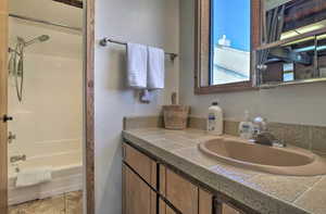 Bathroom featuring tub / shower combination and vanity