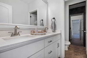 Bathroom with vanity, toilet, and tile patterned floors