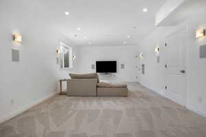 Unfurnished living room featuring light colored carpet