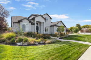 View of front of house with a front yard