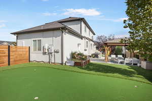 Rear view of house with a gazebo and a patio