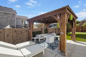 View of patio featuring a gazebo and an outdoor hangout area