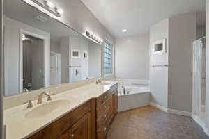 Full bathroom with vanity, independent shower and bath, toilet, and tile patterned flooring