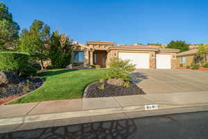 View of front facade featuring a garage and a front lawn