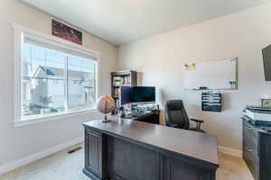 Office with a wealth of natural light and light colored carpet