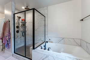 Bathroom featuring independent shower and bath