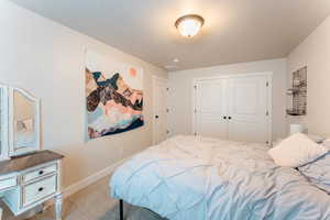 Bedroom featuring a closet and carpet flooring