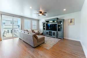 Living room featuring light hardwood / wood-style floors and ceiling fan