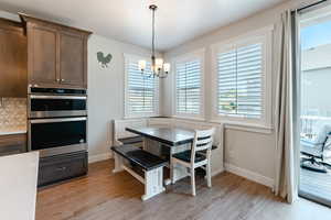 Dining room featuring light hardwood / wood-style flooring and a notable chandelier