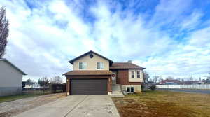 View of front of home featuring a front lawn and a garage