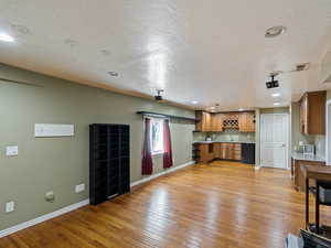 Living room featuring hardwood flooring and wetbar