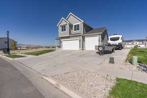 View of front of home featuring a mountain view and a garage