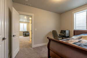 Carpeted bedroom with a textured ceiling