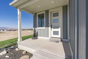 Entrance to property with covered porch and a mountain view