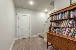 Living area with light carpet and a textured ceiling