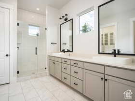 Bathroom featuring vanity and a shower with door