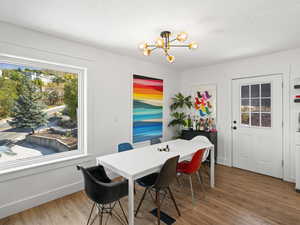 Dining room featuring wood-type flooring, and an inviting chandelier