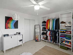 bedroom featuring ceiling fan and light colored carpet