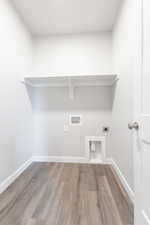 Laundry room featuring hardwood / wood-style floors, hookup for a washing machine, and hookup for an electric dryer