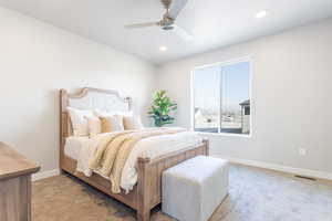 Carpeted bedroom with ceiling fan