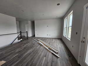 Empty room featuring a textured ceiling and dark hardwood / wood-style flooring