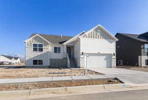 View of front of property with a garage and a mountain view