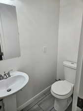 Bathroom featuring sink, hardwood / wood-style flooring, and toilet