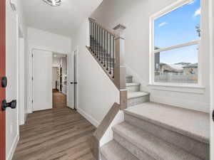 Stairway featuring hardwood / wood-style floors