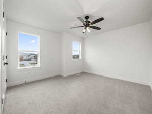 Bedroom with light carpet and ceiling fan