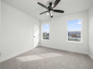 2nd Bedroom Upstairs with ceiling fan and plenty of natural light