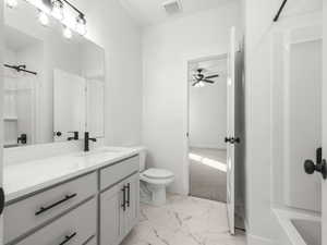 Main floor Full bathroom with vanity, toilet, tub / shower combination, and ceiling fan