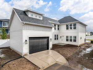 View of rear facade featuring a garage