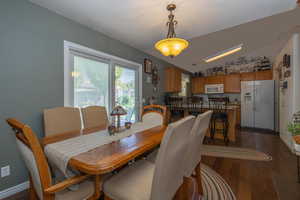 Dining area featuring vaulted ceiling and dark hardwood / wood floors