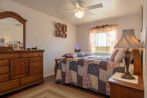 Bedroom with dark wood flooring and ceiling fan