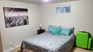 Bedroom with light colored carpet