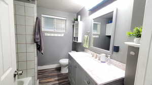 Bathroom with toilet, vanity, and LVP